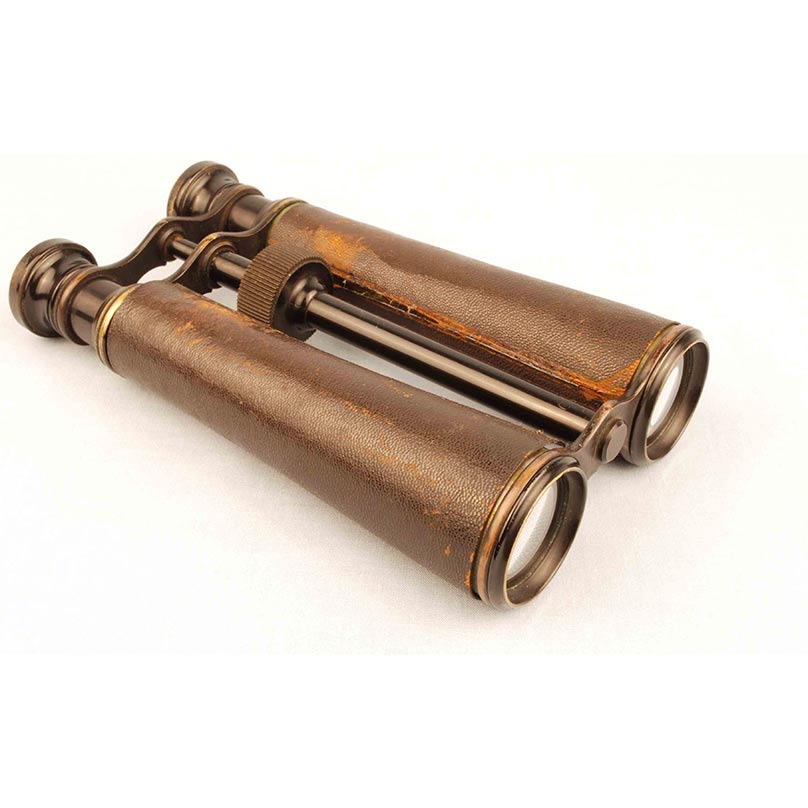 antique binoculars made of leather, wood, and metal
