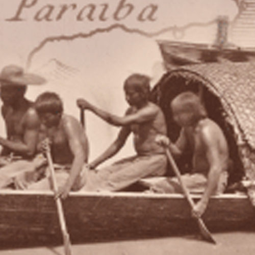 indigenous people paddling a raft